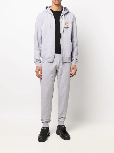 Shop Moschino Logo-waistband Trousers In Grau