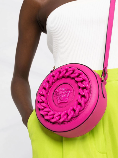 Shop Versace La Medusa Round Crossbody Bag In Pink