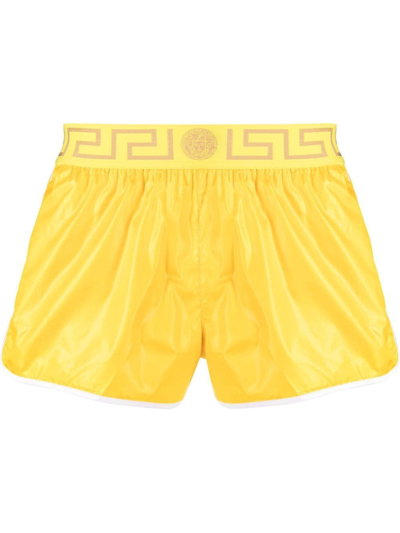 Shop Versace Greca-logo Swim Shorts In Yellow