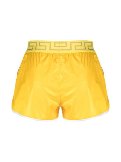 Shop Versace Greca-logo Swim Shorts In Yellow