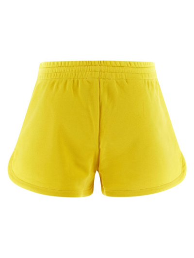 Shop Moschino Embossed Multicolor Logo Shorts In Yellow