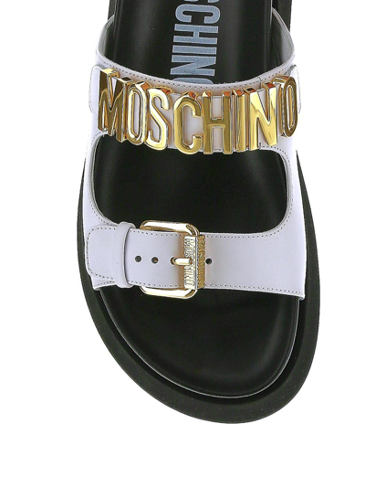 Shop Moschino Logo Plaque Flat Sandals In White