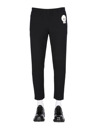 Shop Alexander Mcqueen Jogging Pants With Embroidered Skull In Black