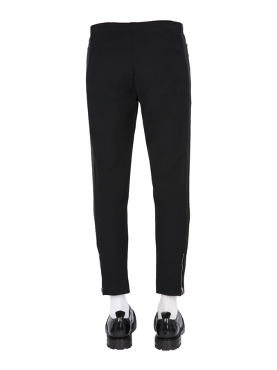 Shop Alexander Mcqueen Jogging Pants With Embroidered Skull In Black