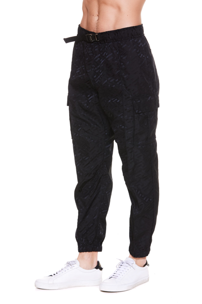 Shop Versace La Greca Print Pants In Black