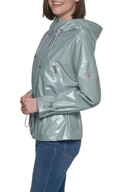 Shop Guess Hooded Holographic Anorak Rain Coat In Light Blue