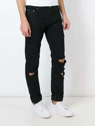 Shop Saint Laurent Ripped Slim Fit Jeans In Black