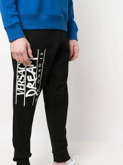 Shop Versace Logo-print Track Pants In Schwarz