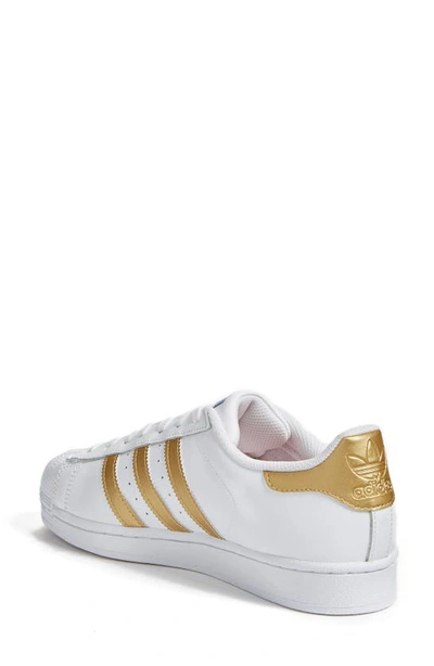 Shop Adidas Originals Superstar Sneaker In White/ Gold