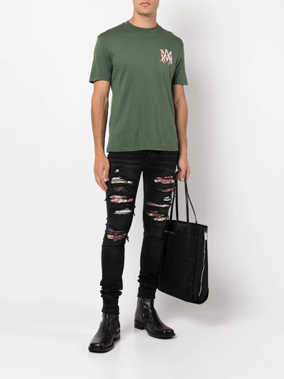 Shop Amiri Ripped Skinny Jeans In Schwarz