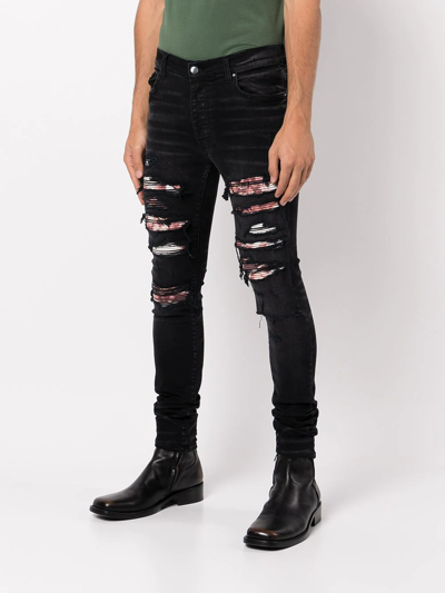 Shop Amiri Ripped Skinny Jeans In Schwarz