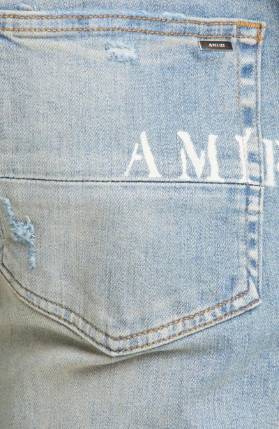 Shop Amiri Hibiscus Stencil Distressed Jeans In Light Indi