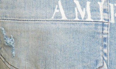 Shop Amiri Hibiscus Stencil Distressed Jeans In Light Indi