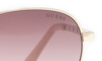 Shop Guess 55mm Oval Sunglasses In Gold / Gradient Brown