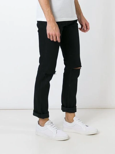 Shop Saint Laurent Distressed Slim Jeans In Black
