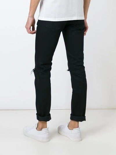 Shop Saint Laurent Distressed Slim Jeans In Black