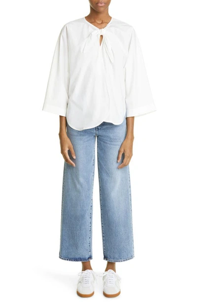 Shop Totême Rigid Organic Cotton Flare Leg Jeans In Worn Blue