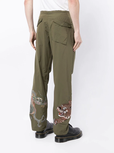 Shop Maharishi Embroidered Dragon Tiger Panelled Trousers In Green