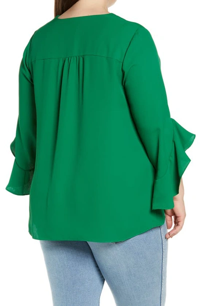Shop Vince Camuto Flutter Sleeve Crossover Georgette Tunic Top In Rich Meadow