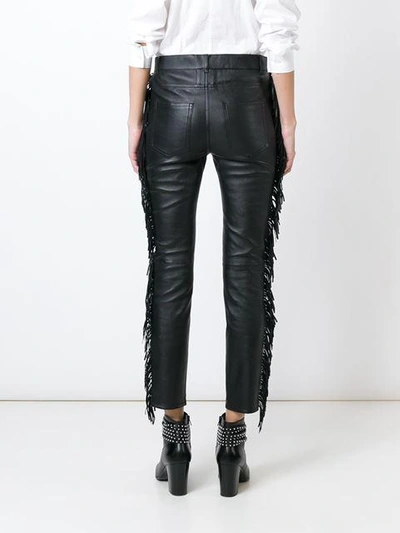 Shop Saint Laurent Fringed Leather Trousers In Black