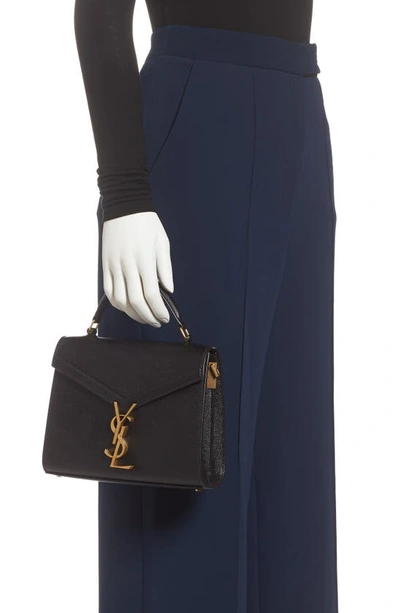 Shop Saint Laurent Mini Cassandra Leather Top Handle Bag In Noir