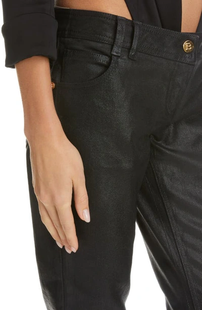 Shop Balmain Coated Low Rise Flare Cuff Bootcut Jeans In Noir