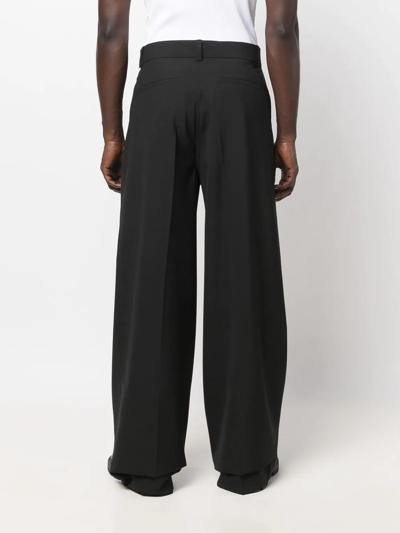 Shop Nanushka Pleat-detail Wide-leg Trousers In Black