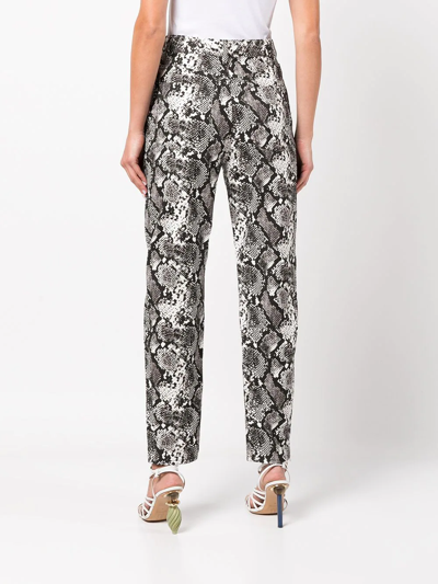 Shop Attico Tapered Snakeskin-effect Trousers In 黑色