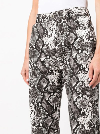 Shop Attico Tapered Snakeskin-effect Trousers In 黑色