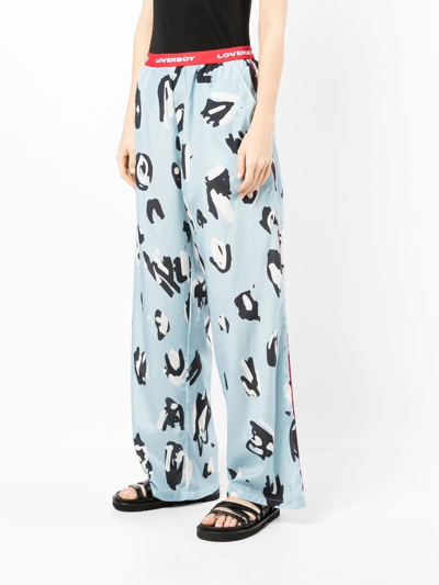 Shop Charles Jeffrey Loverboy Abstract-print Logo-waist Trousers In 蓝色