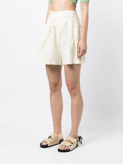 Shop Forte Forte Pleat-detail Buttoned Knee-length Shorts In 黄色