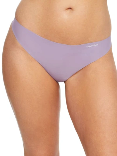 Shop Calvin Klein Invisibles Thong In Purple Essence