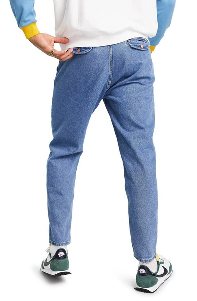 Shop Asos Design Double Pleat Tapered Jeans In Medium Blue