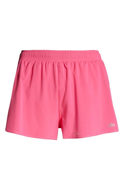 Shop Alo Yoga Stride Shorts In Pink Fuchsia