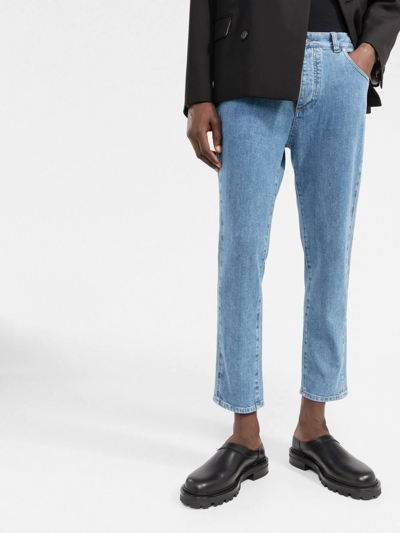 Shop Balmain Embossed-logo Slim-cut Cropped Jeans In Blue