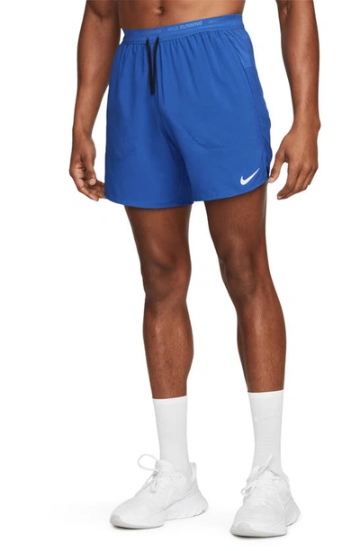 Shop Nike Dri-fit Stride Unlined Running Shorts In Game Royal/ Black