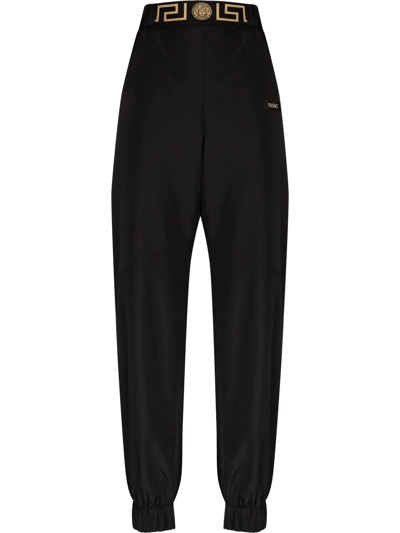 Shop Versace Logo-print Track Pants In Schwarz