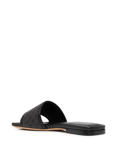 Shop Anine Bing Ria Monogram-print Slides In Black