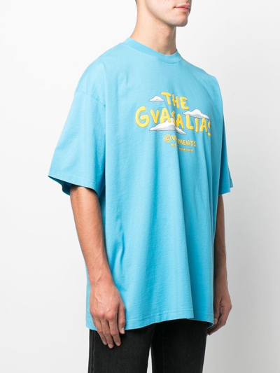 Shop Vetements The Gvasalias Cartoon Logo-print T-shirt In Blue