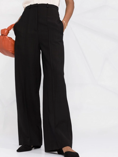 Shop Totême High-waisted Flared Trousers In Black