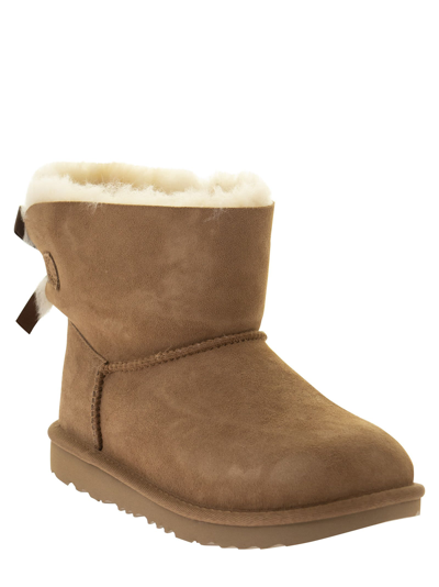 Shop Ugg Mini Bailey Bow Ii - Ankle Boot In Chestnut
