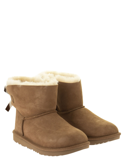 Shop Ugg Mini Bailey Bow Ii - Ankle Boot In Chestnut