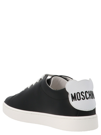 Shop Moschino Side Logo Sneakers In White/black