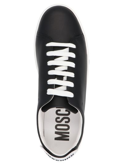 Shop Moschino Side Logo Sneakers In White/black