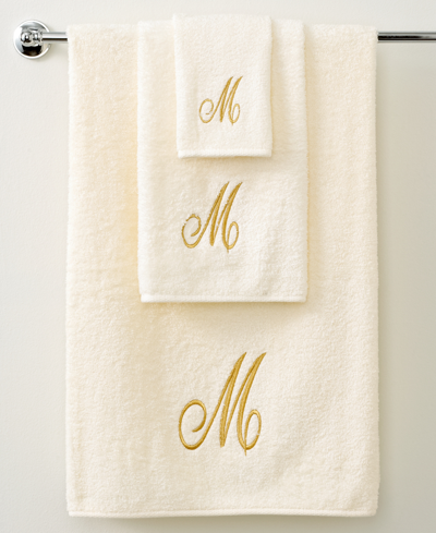 Shop Avanti Monogram Initial Script Ivory & Gold Hand Towel, 16" X 30" In White