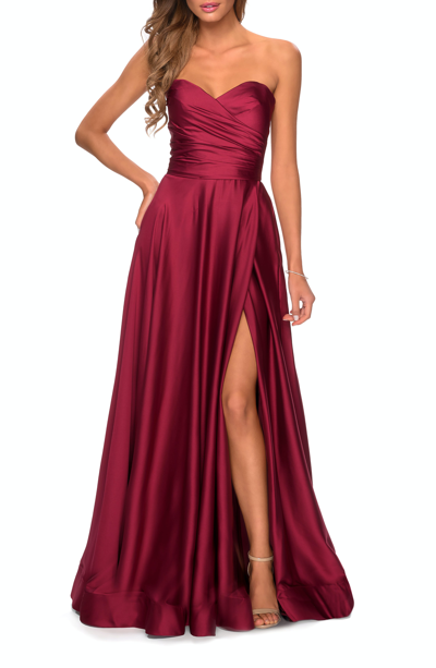 Shop La Femme Strapless Satin Gown With Pleated Bodice And Slit In Red