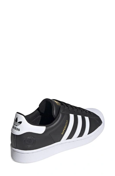 Shop Adidas Originals Superstar Sneaker In Black/ White/ Gold Metallic