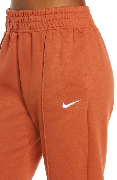 Shop Nike Sportswear Essential Fleece Pants In Burnt Sunrise/ White