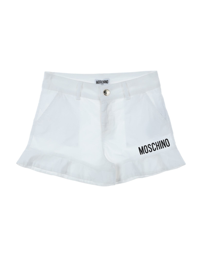 Shop Moschino Teen Shorts & Bermuda Shorts In White