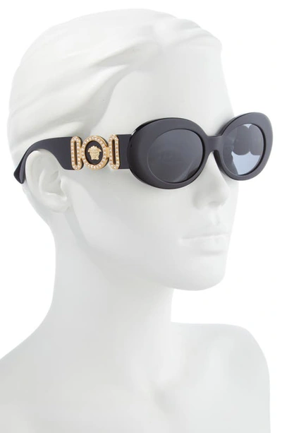 Shop Versace 54mm Irregular Oval Sunglasses In Black/ Dark Grey